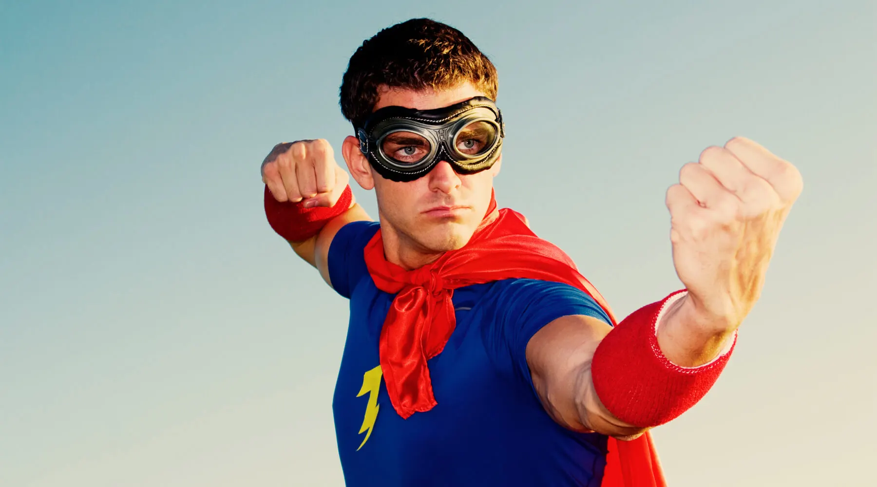 Man wearing a red and blue costume posing as a superhero